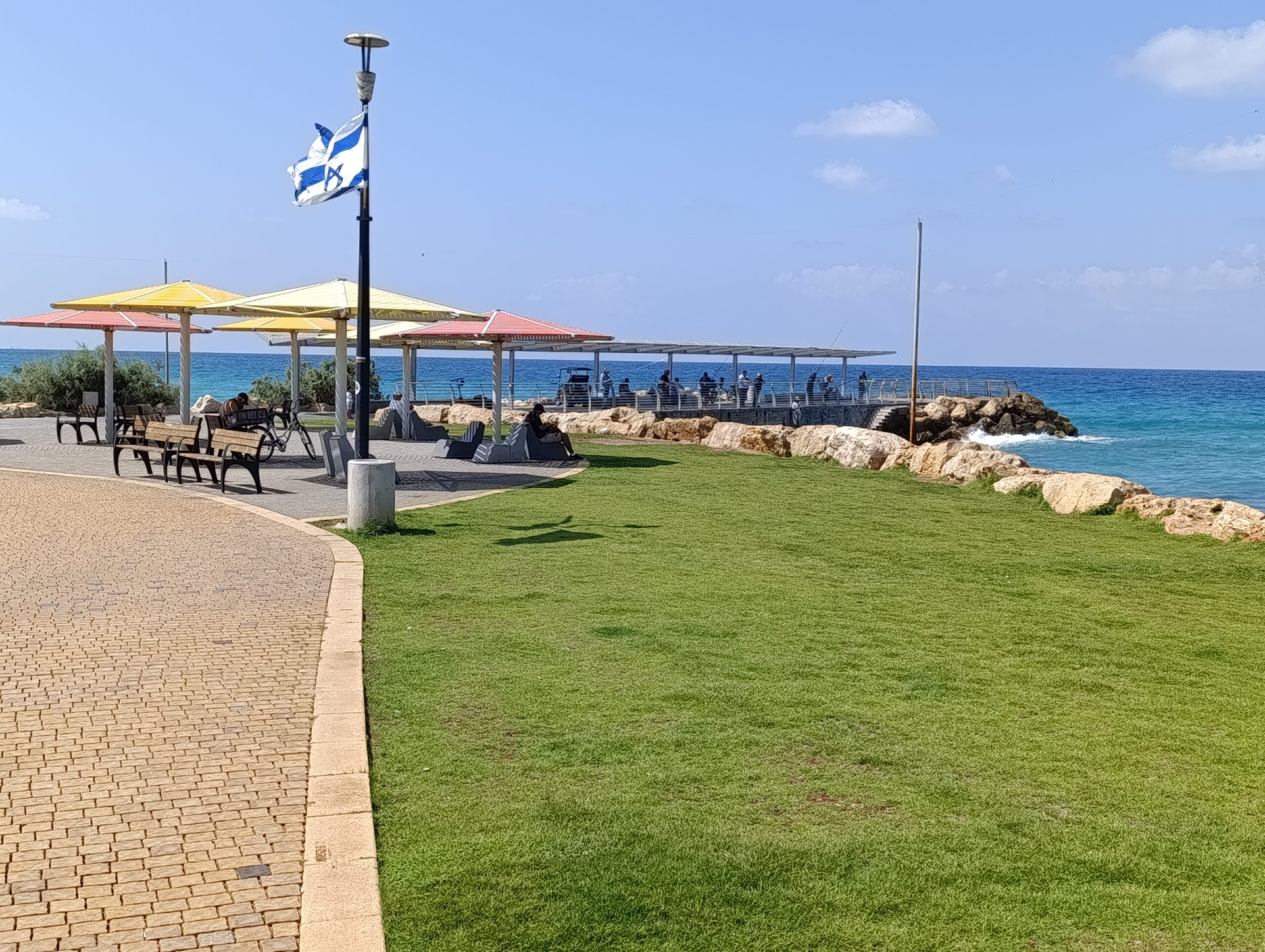 Residents enjoying the beach in Nahariya beside the Mediterranean Sea.